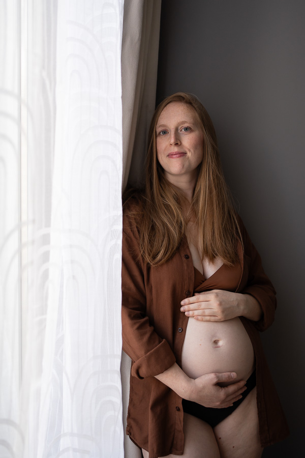 Future-maman enceinte près de la fenêtre